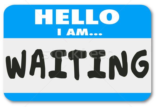 5466974_stock-photo-hello-i-am-waiting-name-tag-patient-anticipation-late-delay
